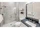 Modern bathroom with sleek glass shower and vanity with stylish black countertop at 5958 Talon Preserve Dr, Nokomis, FL 34275