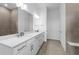 Clean bathroom featuring a double sink, quartz countertops, and a large mirror at 5958 Talon Preserve Dr, Nokomis, FL 34275
