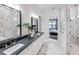 Modern bathroom with dual vanity, marble countertops, and walk-in shower at 5958 Talon Preserve Dr, Nokomis, FL 34275