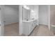 Large bathroom featuring dual sink vanities, quartz countertops, and open closet at 5958 Talon Preserve Dr, Nokomis, FL 34275