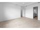 Open bedroom featuring tile floors, and an attached bathroom with double doors at 5958 Talon Preserve Dr, Nokomis, FL 34275