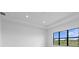 Bright bedroom featuring large window overlooking a lawn at 5958 Talon Preserve Dr, Nokomis, FL 34275