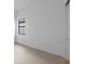 A bright bedroom is adjacent to a sliding closet, with neutral tile floors at 5958 Talon Preserve Dr, Nokomis, FL 34275
