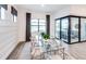 Dining room with glass table and seating for six, filled with natural light at 5958 Talon Preserve Dr, Nokomis, FL 34275