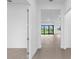 Bright hallway leads to rooms with recessed lighting and tile floors at 5958 Talon Preserve Dr, Nokomis, FL 34275