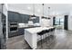 Modern kitchen with stainless steel appliances, large island, and adjacent dining area at 5958 Talon Preserve Dr, Nokomis, FL 34275