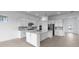 Bright kitchen with white cabinets, an island, stainless steel appliances, and tiled backsplash at 5958 Talon Preserve Dr, Nokomis, FL 34275