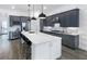 Spacious kitchen featuring gray cabinets, stainless appliances, and a bright island at 5958 Talon Preserve Dr, Nokomis, FL 34275