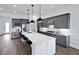 Modern kitchen with gray cabinets, stainless steel appliances, and large center island at 5958 Talon Preserve Dr, Nokomis, FL 34275