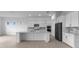 Bright kitchen features white cabinets, a large center island, and stainless steel appliances at 5958 Talon Preserve Dr, Nokomis, FL 34275