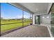 A screened lanai with brick pavers overlooks a grassy yard and a beautiful pond view at 5958 Talon Preserve Dr, Nokomis, FL 34275