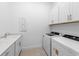 A bright laundry room offers new appliances and a utility sink at 5958 Talon Preserve Dr, Nokomis, FL 34275