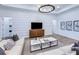 Bright living room showcasing shiplap accent wall and neutral decor at 5958 Talon Preserve Dr, Nokomis, FL 34275