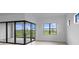 Bright living room featuring sliding glass doors to a patio with beautiful outdoor views at 5958 Talon Preserve Dr, Nokomis, FL 34275