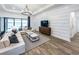 Open-concept living room with modern furnishings and view to outdoor patio at 5958 Talon Preserve Dr, Nokomis, FL 34275