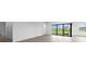 A spacious living room with an exterior view through large sliding doors and an adjacent hallway at 5958 Talon Preserve Dr, Nokomis, FL 34275