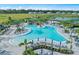 A sprawling community pool with various seating areas and a picturesque waterfall feature at 5958 Talon Preserve Dr, Nokomis, FL 34275