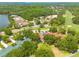 Aerial view of the property near a golf course and lush landscaping at 60 Woodridge Cir, Oldsmar, FL 34677
