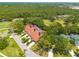 An aerial view of a townhouse community with lush greenery, mature trees, and well-maintained landscaping at 60 Woodridge Cir, Oldsmar, FL 34677
