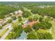 Aerial view of the home showcasing its location near lush landscaping and a golf course at 60 Woodridge Cir, Oldsmar, FL 34677