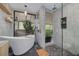 Elegant bathroom with a soaking tub, walk-in shower, and stylish gray tiling at 60 Woodridge Cir, Oldsmar, FL 34677