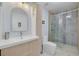 Updated bathroom boasts modern vanity, sleek fixtures, and glass-enclosed shower at 60 Woodridge Cir, Oldsmar, FL 34677