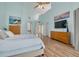 Bright bedroom with a vaulted ceiling, wood floors, and a ladder to the loft at 60 Woodridge Cir, Oldsmar, FL 34677