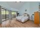 Bright bedroom with wood floors, slider to deck, and stylish decor at 60 Woodridge Cir, Oldsmar, FL 34677