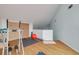 Bonus room featuring exercise equipment, a large window, and light wood floors at 60 Woodridge Cir, Oldsmar, FL 34677