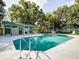 Community pool featuring clear, cool water and lounge chairs on a sunny day at 60 Woodridge Cir, Oldsmar, FL 34677