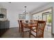 Elegant dining room with wood table and chairs, a stylish light fixture, and neutral wall color at 60 Woodridge Cir, Oldsmar, FL 34677
