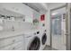 Functional laundry room features washer, dryer, and ample storage space at 60 Woodridge Cir, Oldsmar, FL 34677
