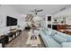 Open-concept living room with stairs, fireplace, neutral color palette, wood floors, and ample seating at 60 Woodridge Cir, Oldsmar, FL 34677