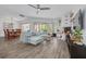 Open-concept living area with comfortable seating, a fireplace, and seamless flow to the dining area at 60 Woodridge Cir, Oldsmar, FL 34677