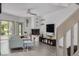 Bright living room with corner fireplace, entertainment center, wood flooring, and adjacent sunroom at 60 Woodridge Cir, Oldsmar, FL 34677