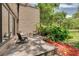 A private outdoor patio with chairs surrounded by lush greenery at 60 Woodridge Cir, Oldsmar, FL 34677