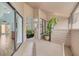 Outdoor patio area with plants and a view of the bathroom and living room at 60 Woodridge Cir, Oldsmar, FL 34677