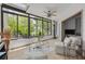 Light-filled sunroom with expansive windows, tile floors, skylight, and neutral decor, creating a relaxing atmosphere at 60 Woodridge Cir, Oldsmar, FL 34677