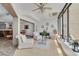 Bright sunroom with tile flooring, comfortable seating, piano, and large windows offering serene outdoor views at 60 Woodridge Cir, Oldsmar, FL 34677