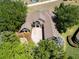 An aerial view shows the property with a driveway, landscaping, and proximity to nearby homes and greenery at 607 Vintage Way, Brandon, FL 33511