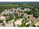 Aerial view showcases a residential neighborhood with well-maintained homes, mature trees, and a lush green landscape at 607 Vintage Way, Brandon, FL 33511