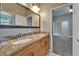 Bathroom with double sink, stone countertop, and a view of the bedroom from the doorway at 607 Vintage Way, Brandon, FL 33511