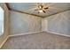 Spacious bedroom featuring neutral carpeting, ceiling fan, and wood trim at 607 Vintage Way, Brandon, FL 33511