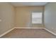 Empty bedroom featuring neutral walls, carpet flooring, a ceiling fan, and a window with blinds at 607 Vintage Way, Brandon, FL 33511