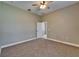 Bedroom with neutral walls, ceiling fan, and carpet flooring with a door leading to a closet or bathroom at 607 Vintage Way, Brandon, FL 33511