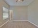 Bedroom with carpet, a window with blinds, a ceiling fan, and a door leading to another room at 607 Vintage Way, Brandon, FL 33511