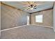 A carpeted bedroom with neutral walls, ceiling fan, and wood trim at 607 Vintage Way, Brandon, FL 33511