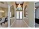 Grand foyer with tile flooring, chandelier, and arched doorways at 607 Vintage Way, Brandon, FL 33511