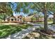 Beautiful home with lush green lawn, mature trees and brick paver driveway at 607 Vintage Way, Brandon, FL 33511