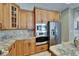 This kitchen features granite countertops, stainless steel appliances, and custom wood cabinets at 607 Vintage Way, Brandon, FL 33511